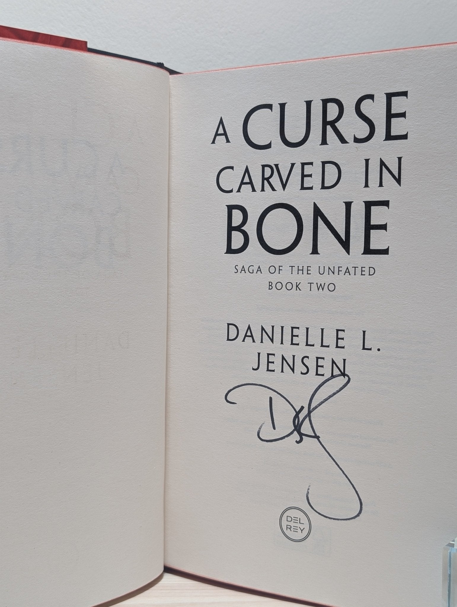 A Curse Carved in Bone by Danielle L. Jensen (Signed First Edition with sprayed edges) - Fialta Books