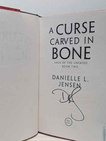 A Curse Carved in Bone by Danielle L. Jensen (Signed First Edition with sprayed edges) - Fialta Books