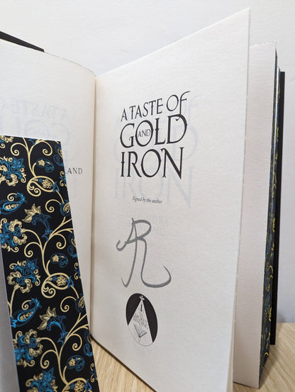 A Taste of Gold and Iron by Alexandra Rowland (Signed First Edition with sprayed edges) - Fialta Books