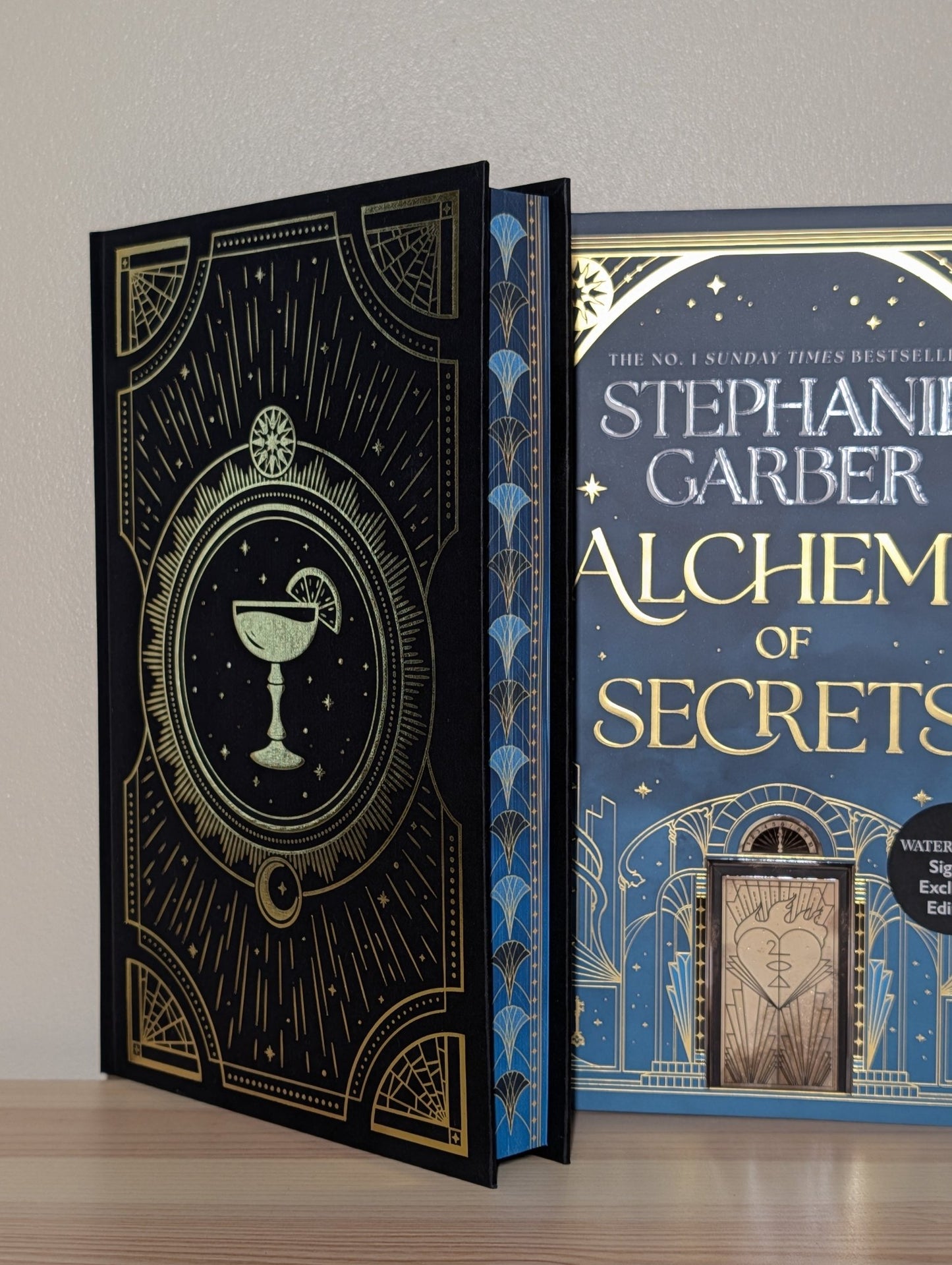 Alchemy of Secrets by Stephanie Garber (Signed with sprayed edges and cocktail cover) - Fialta Books