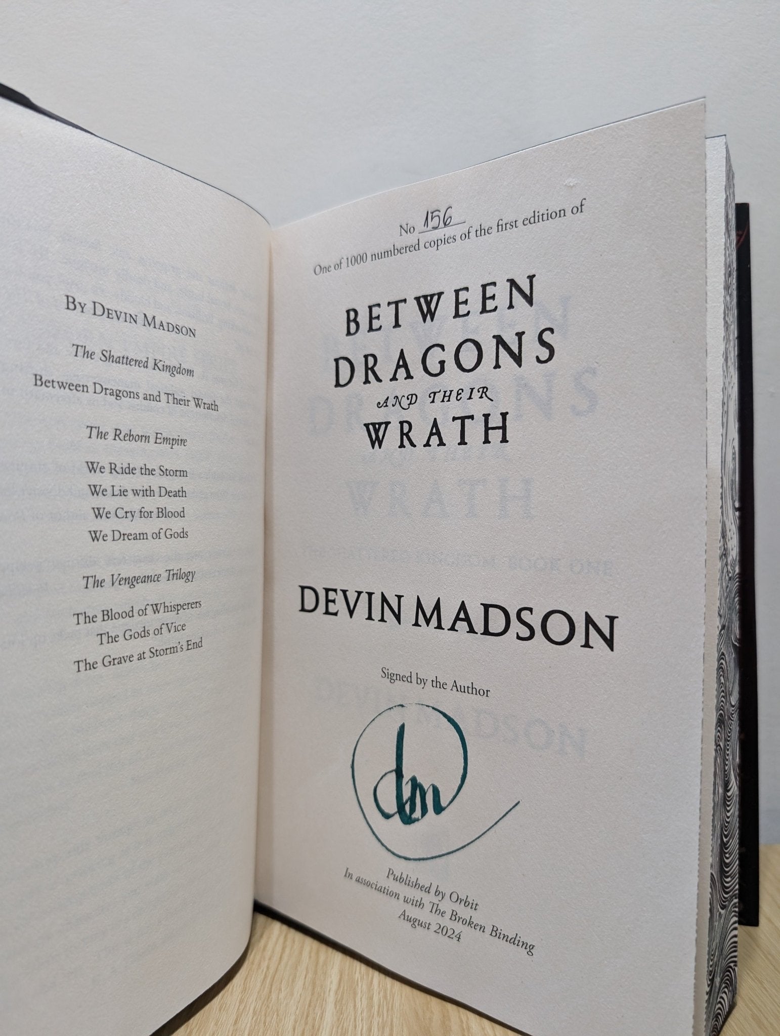 Between Dragons and Their Wrath by Devin Madson (Signed First Edition with sprayed edges) - Fialta Books