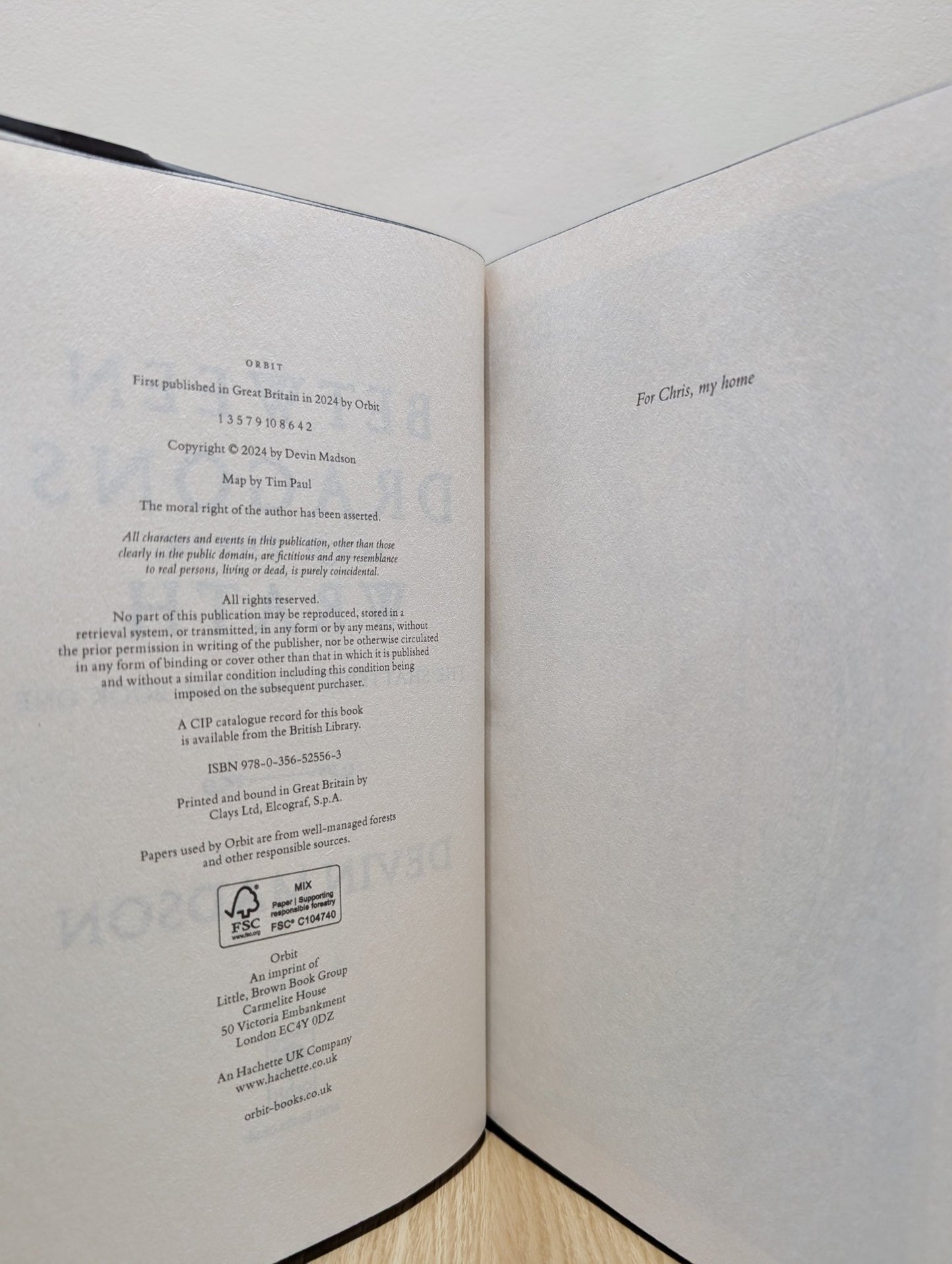 Between Dragons and Their Wrath by Devin Madson (Signed First Edition with sprayed edges) - Fialta Books