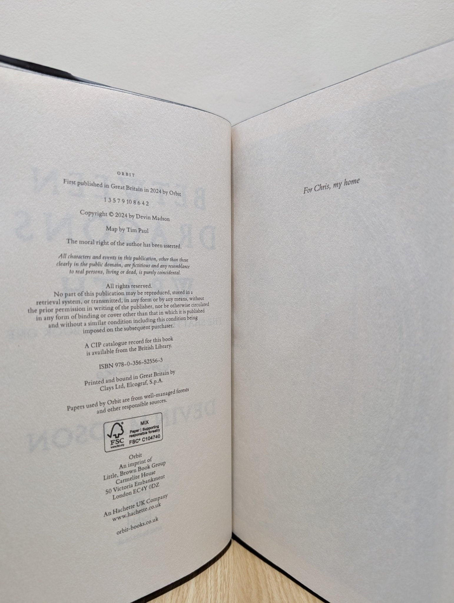 Between Dragons and Their Wrath by Devin Madson (Signed First Edition with sprayed edges) - Fialta Books