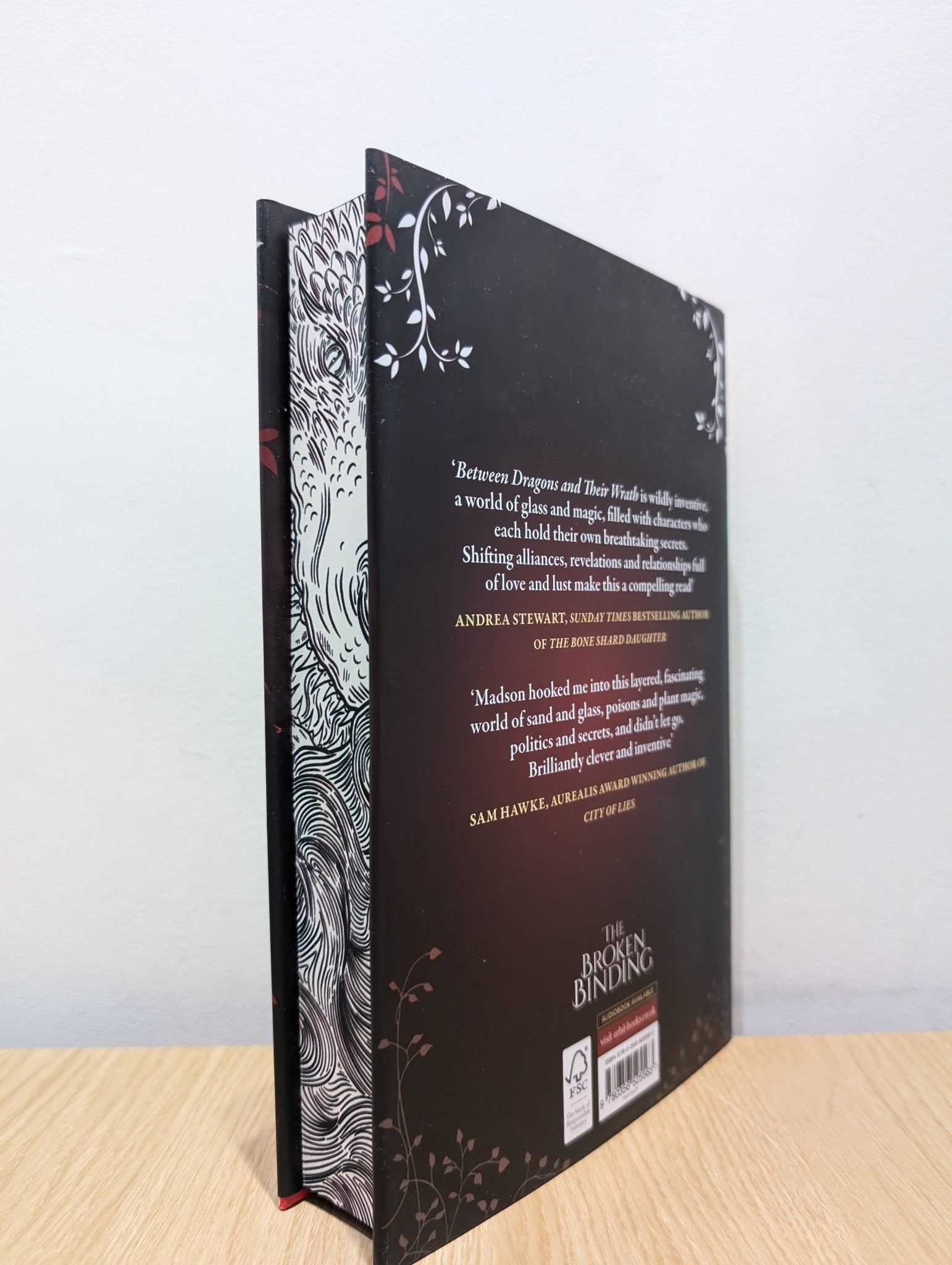 Between Dragons and Their Wrath by Devin Madson (Signed First Edition with sprayed edges) - Fialta Books