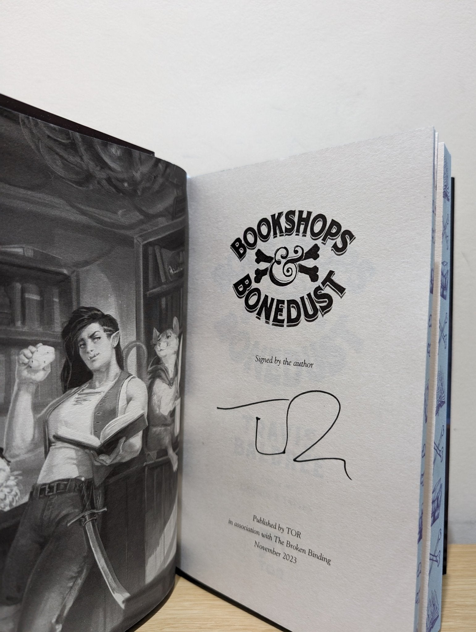 Bookshops & Bonedust by Travis Baldree (Signed First Edition with sprayed edges) - Fialta Books