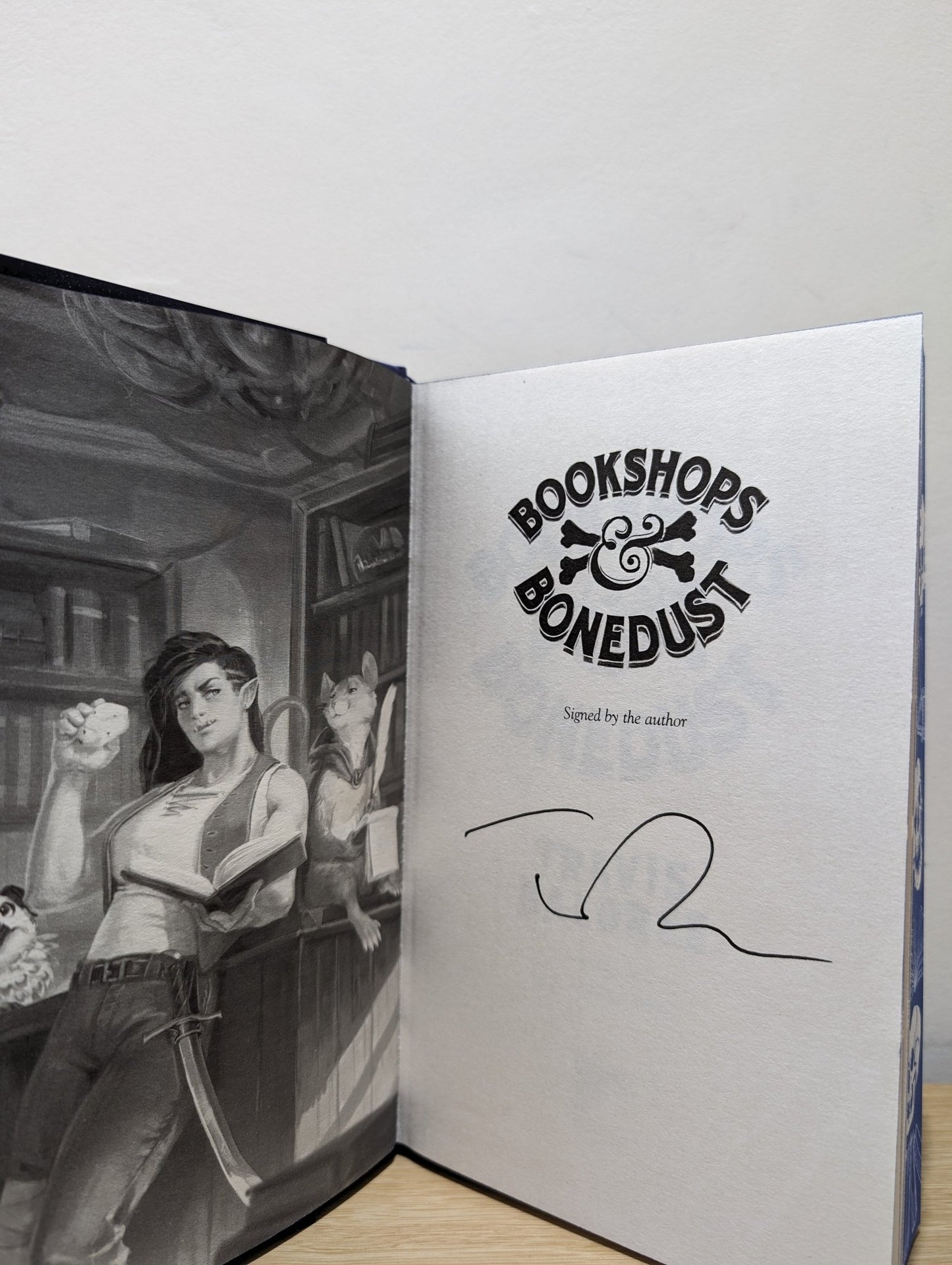 Bookshops & Bonedust by Travis Baldree (Signed First Edition with sprayed skull edges) - Fialta Books