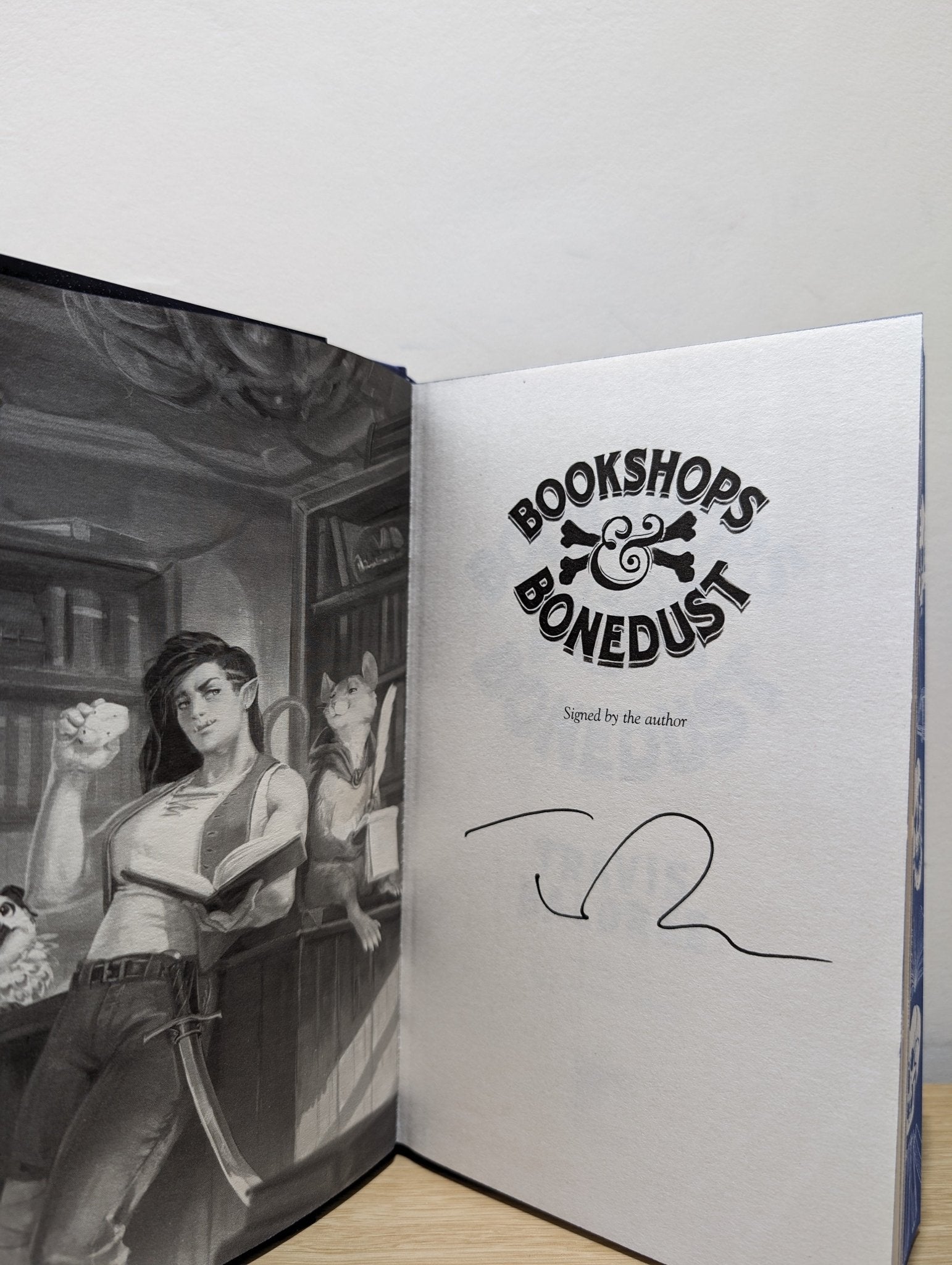 Bookshops & Bonedust by Travis Baldree (Signed First Edition with sprayed skull edges) - Fialta Books