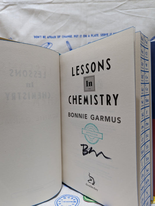 Lessons in Chemistry by Bonnie Garmus (Signed Stamped First Edition with bookmark set and tea towel) - Fialta Books